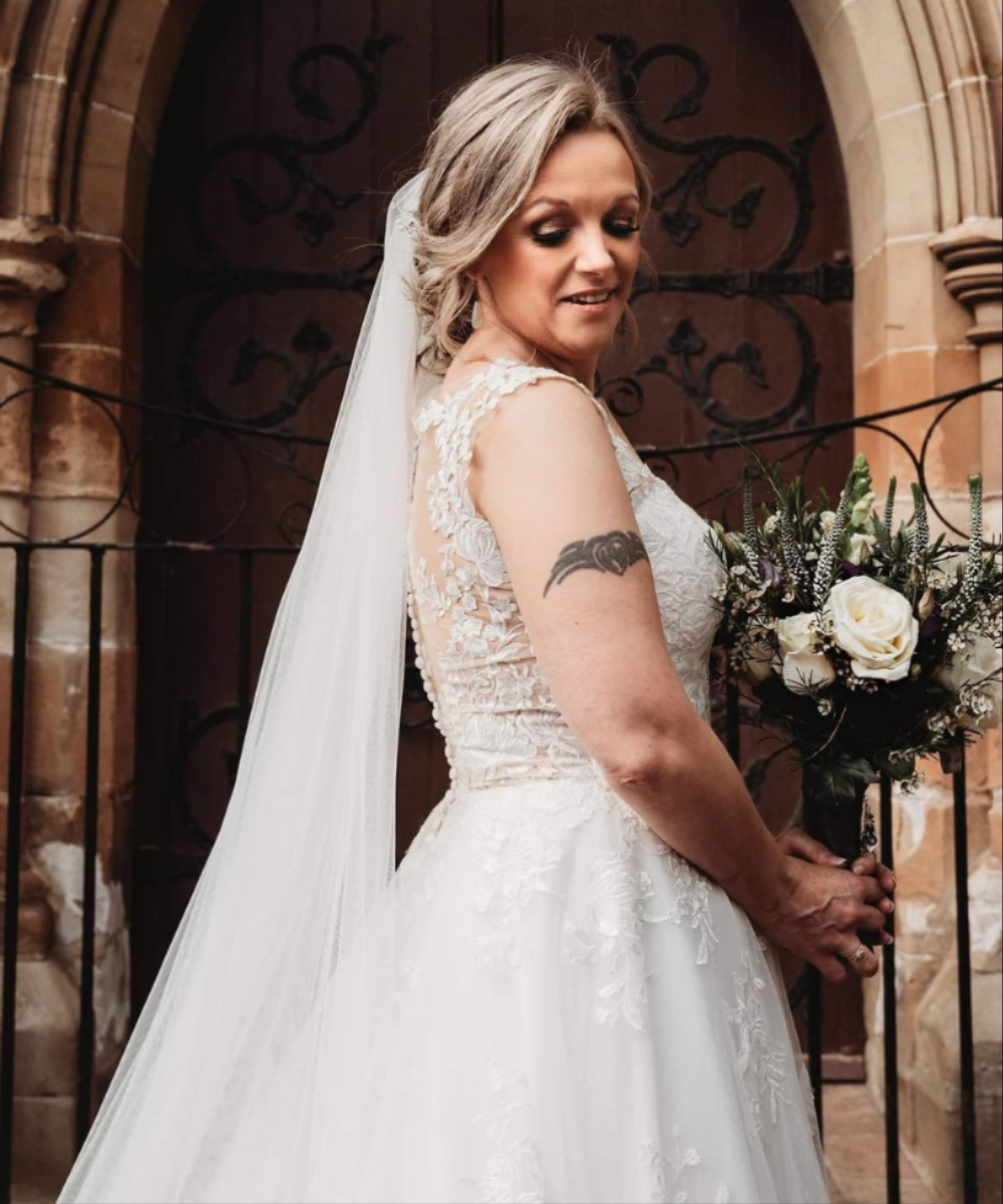 Bride holding wedding flowers by The Flower Shop East Ayrshire