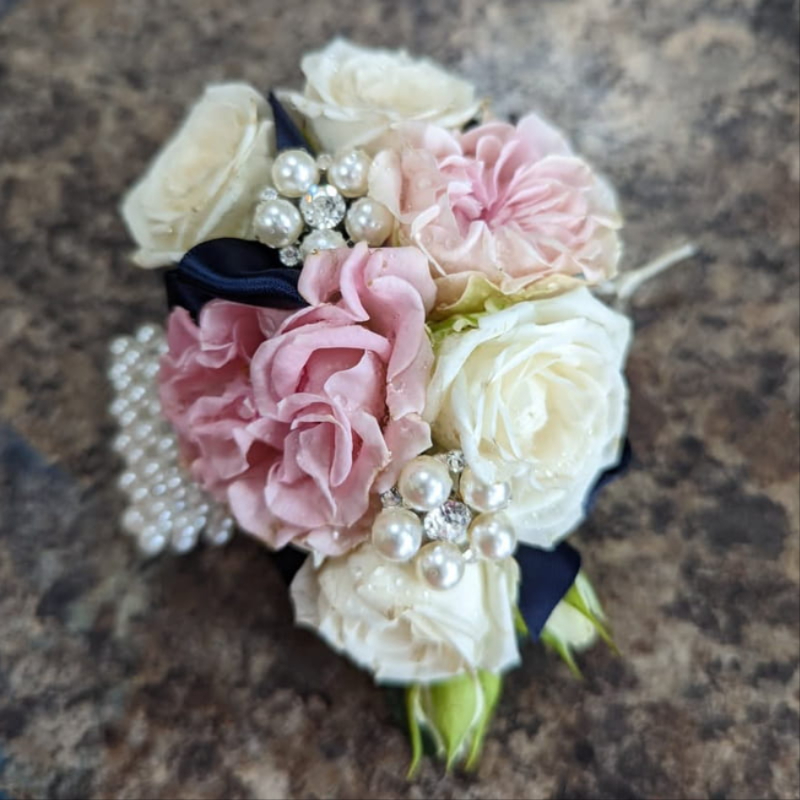 Blush pink buttonholes and corsages by The Flower Shop